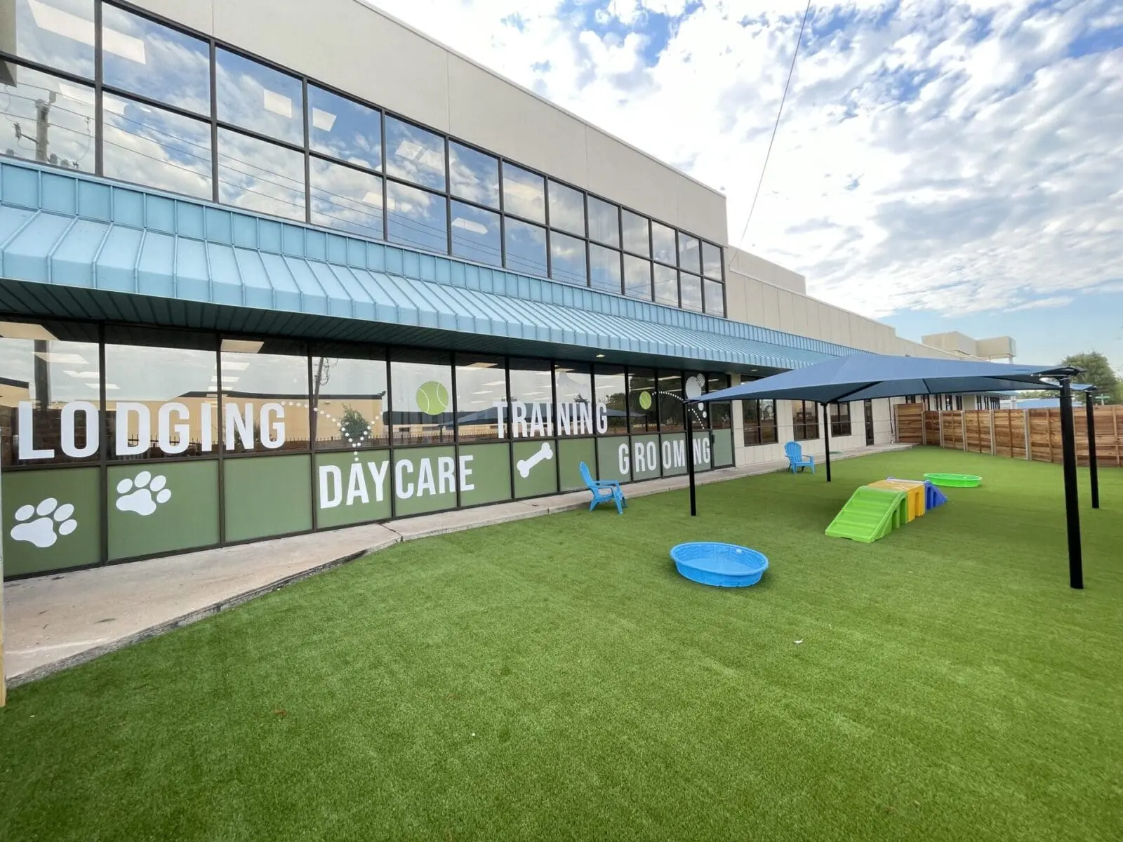 Outdoor dog daycare play area at Meadowlake Pet Resort
